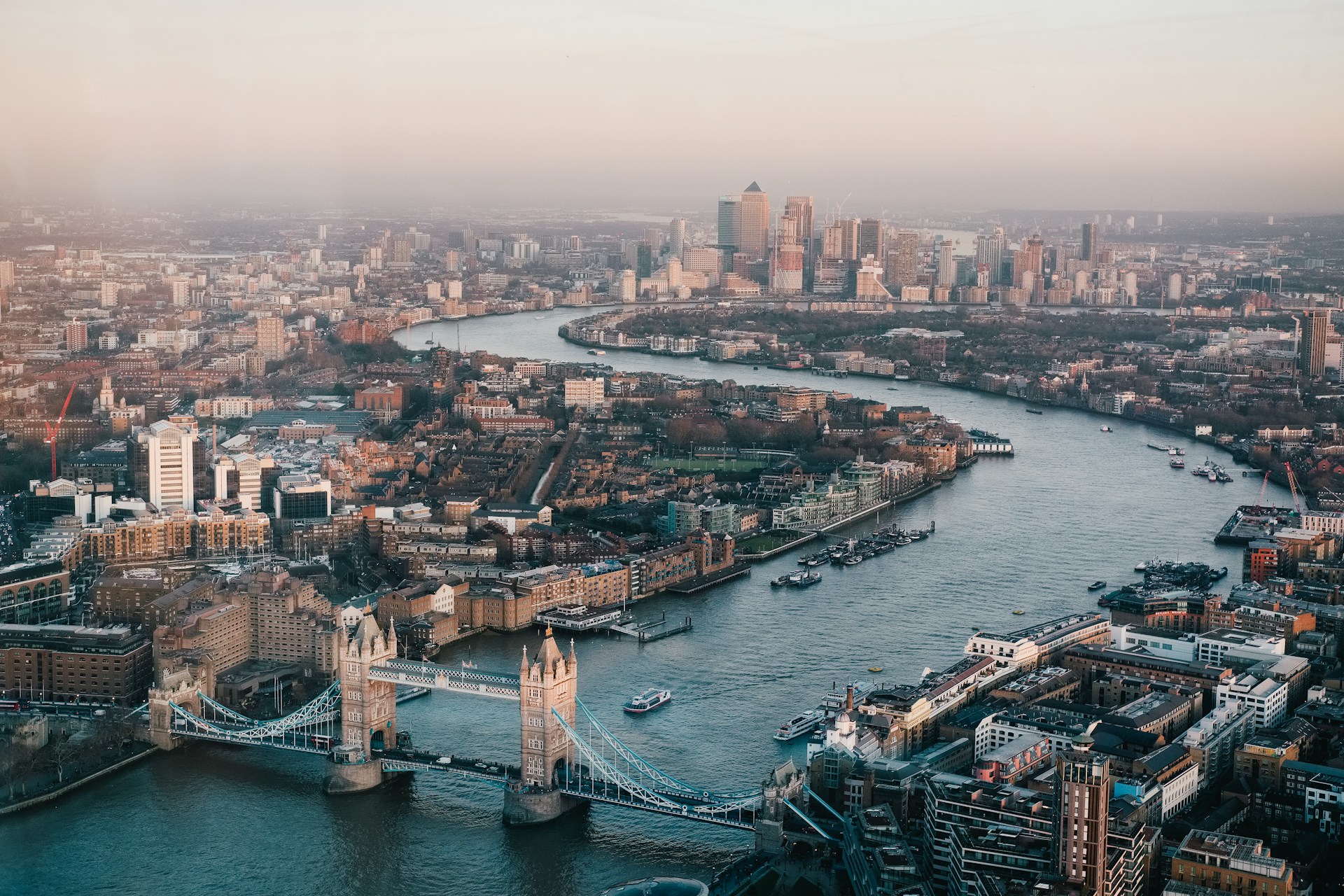 Aerial view of Tower Bridge over the River Thames, London, on a clear blue sky day